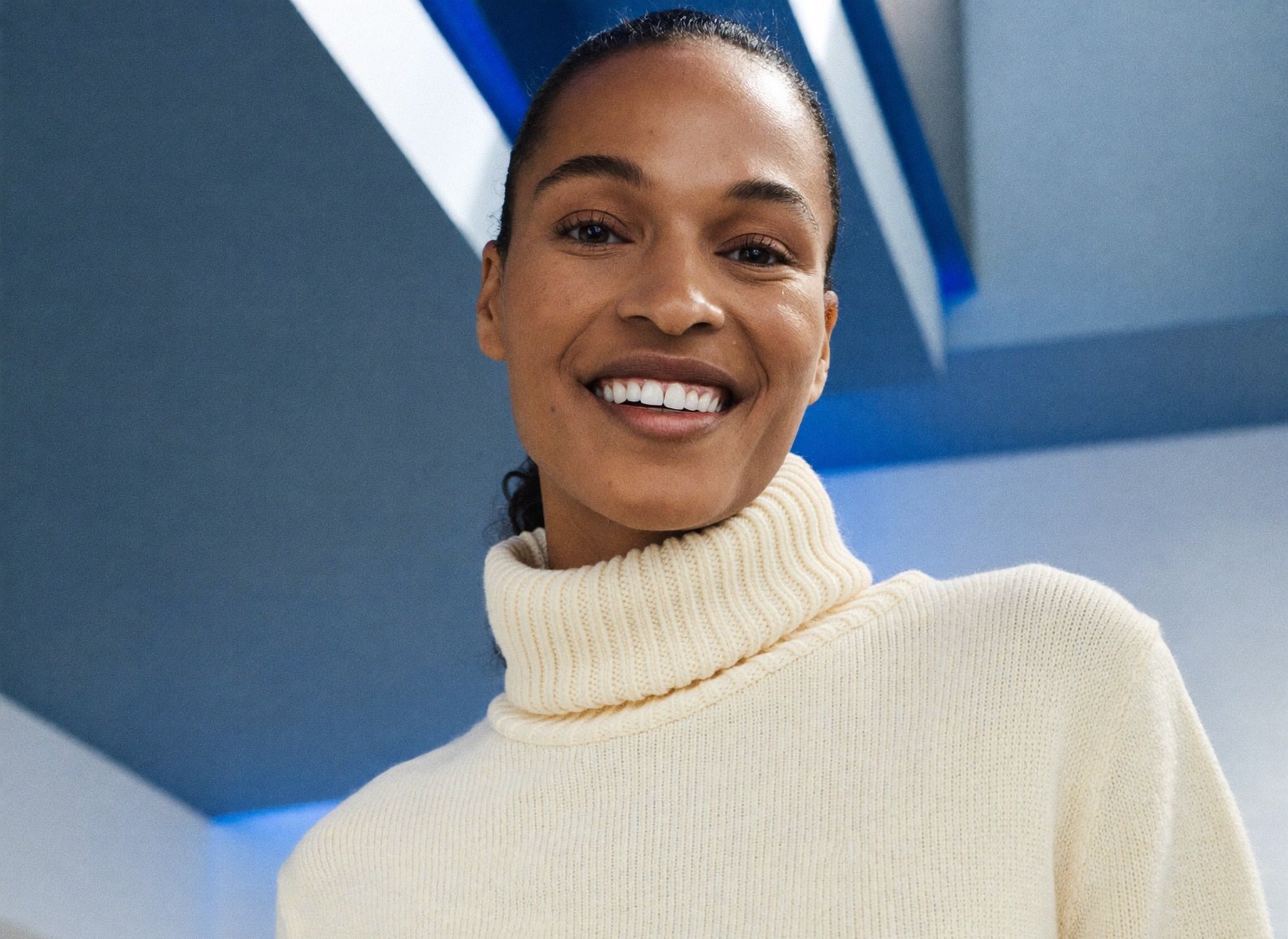 A confident post-pregnancy woman at ease in a bright, modern space