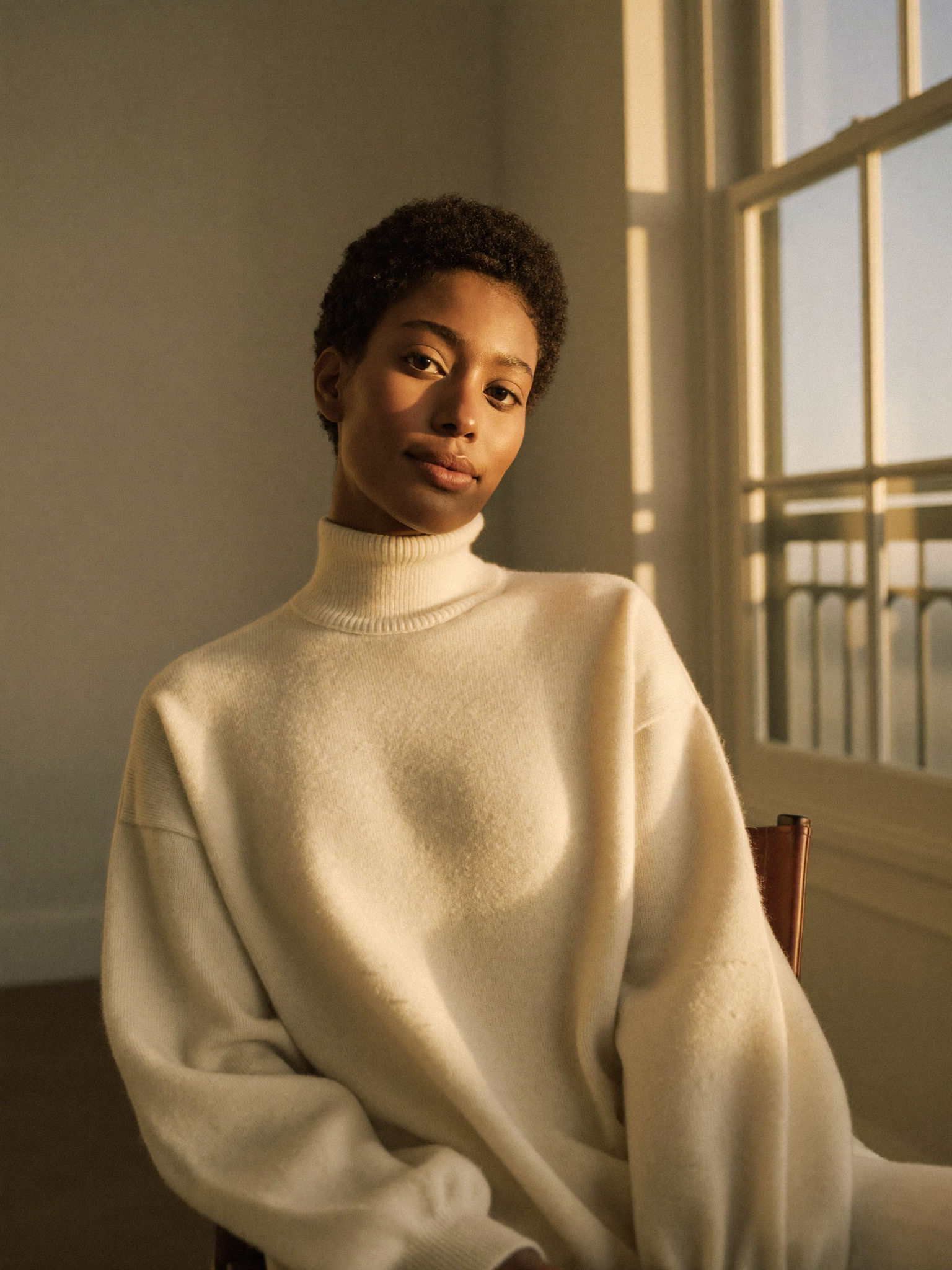 A composed woman in soft natural light, at ease and self-assured after her lift